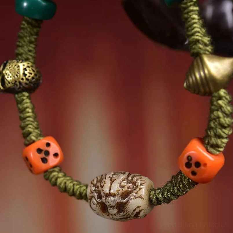 Close up of carved dragon dice bead on Tibetan rope bracelet