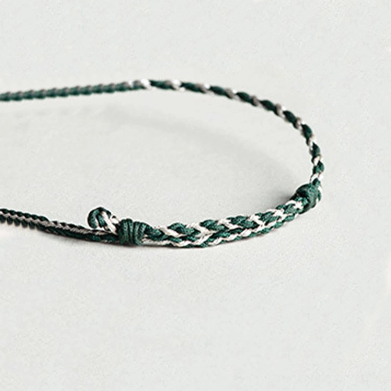 Detailed close up of carved natural jade orchid charm for prosperity bracelet