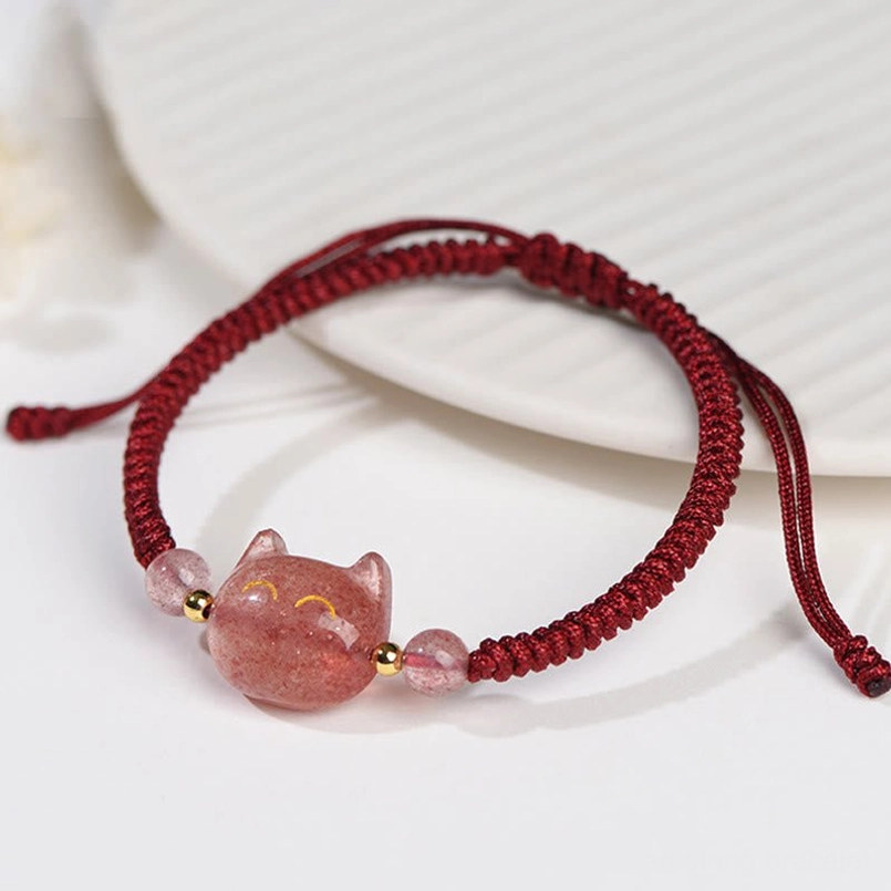 Cat protection bracelet with adjustable red and black cord, showing dual material and binding technique