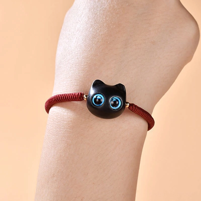 Cat charm bracelet on wrist showing clear view of ebony wood cat pendant