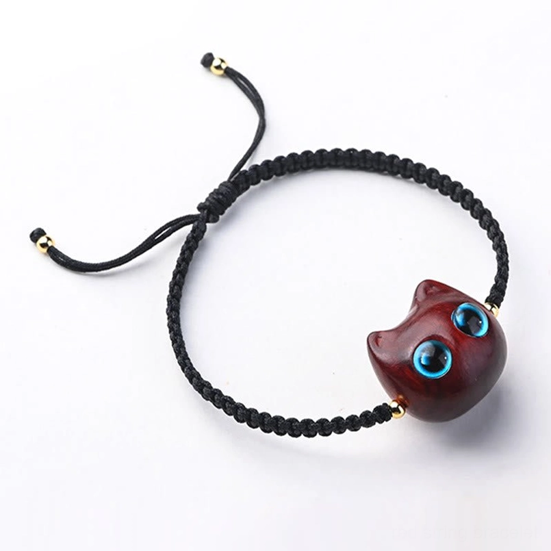 Adjustable red sandalwood cat bracelet pull-tie closure flat lay