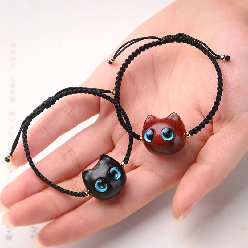 Red sandalwood and ebony cat charm bracelets held in palm handmade design