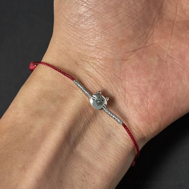 925 sterling silver cat red string bracelet product photography with natural styling