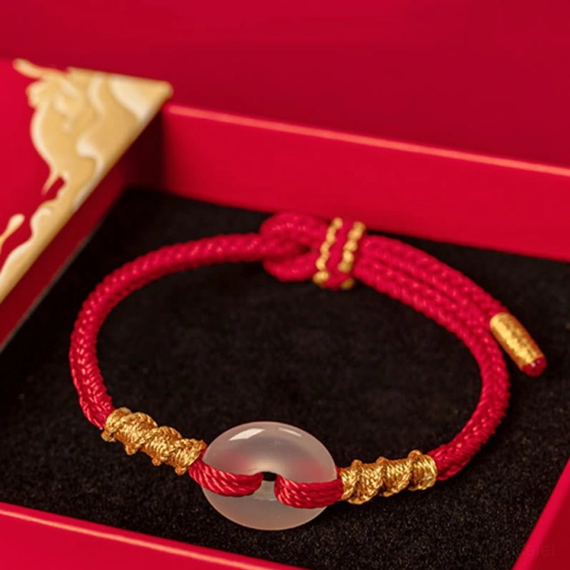 White chalcedony peace buckle bracelet showcasing natural stone texture and golden rope accents