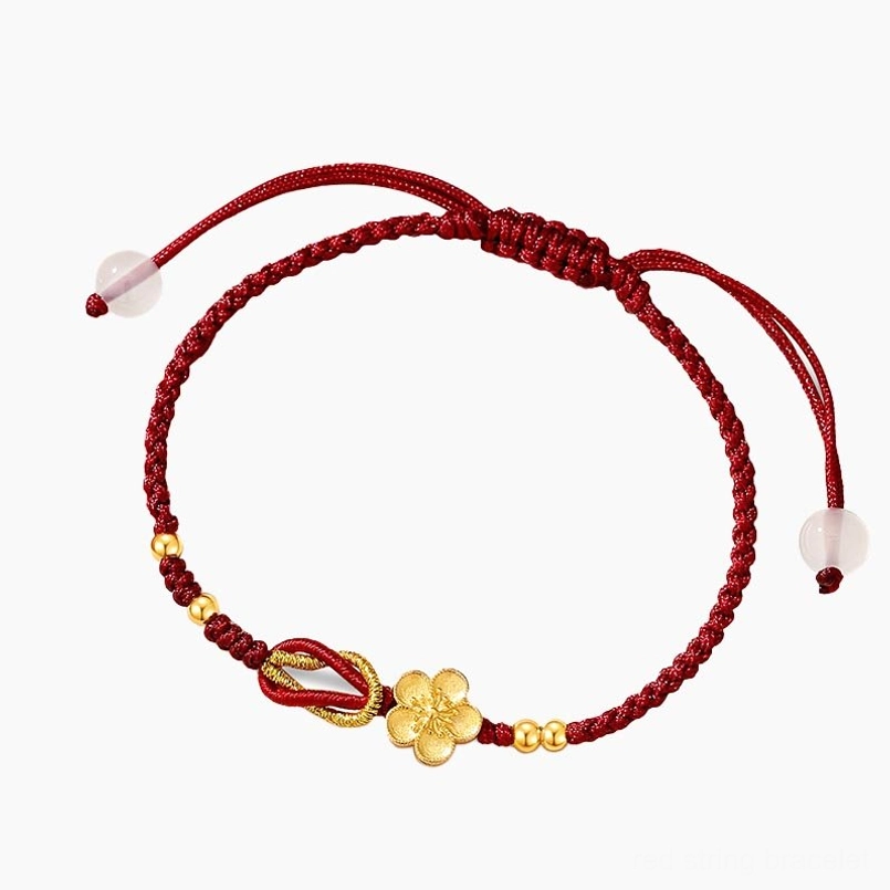 Cherry blossom charm red string bracelet top down flat lay on solid white background