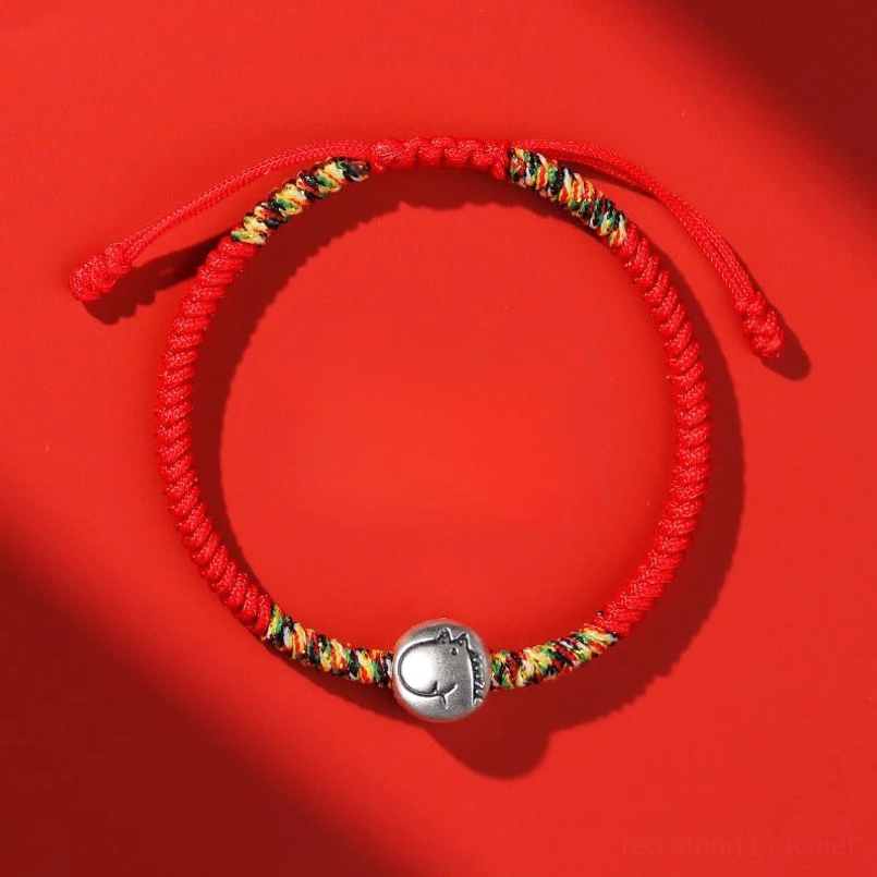 Chinese Zodiac Horse red braided red string bracelet top view on red background