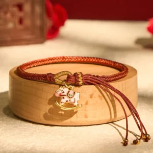 Chinese Zodiac Year of the Horse red string bracelet with rocking horse charm on wooden display