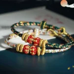 Chinese zodiac lucky multicolor braided red string bracelet top down flat lay view