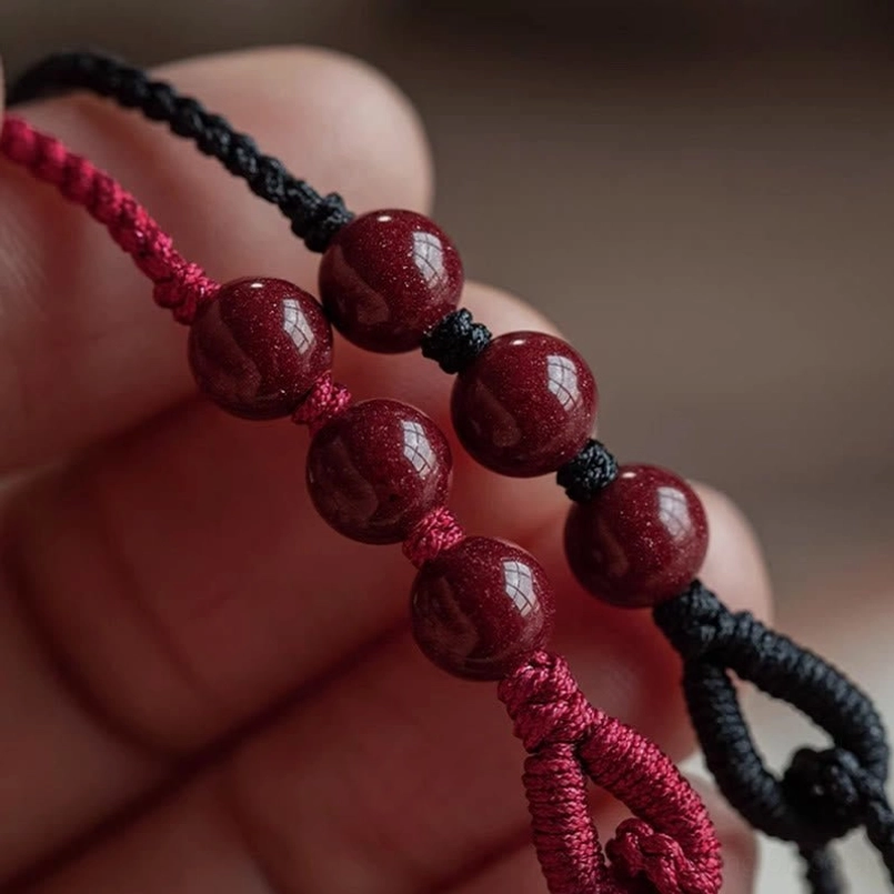 Cinnabar bead red string bracelet lifestyle display shot