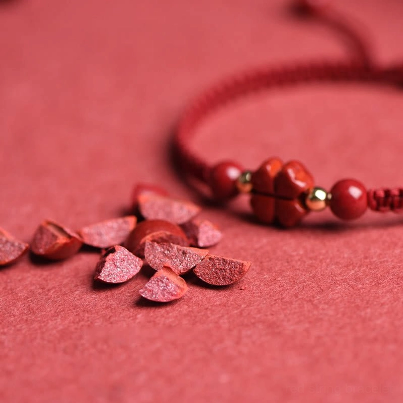 Four-leaf clover cinnabar charm and round beads with raw cinnabar fragments detail