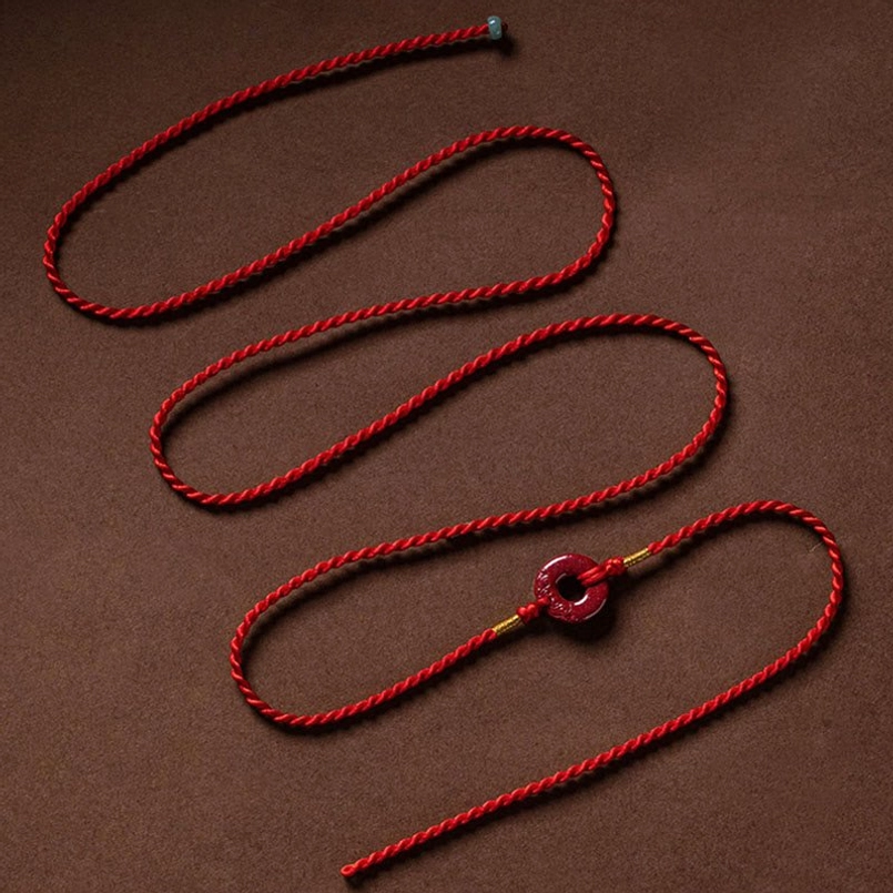Multiple red braided belly chains with natural cinnabar peace buckle charms - product line view