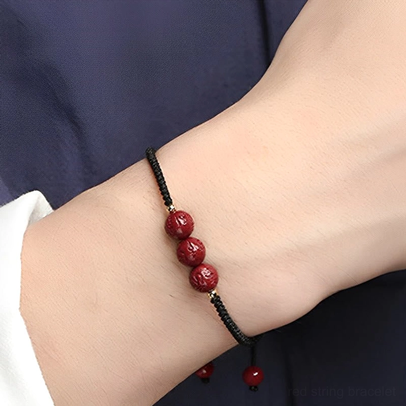 Graduated cinnabar engraved beads with black woven cord adjustable bracelet
