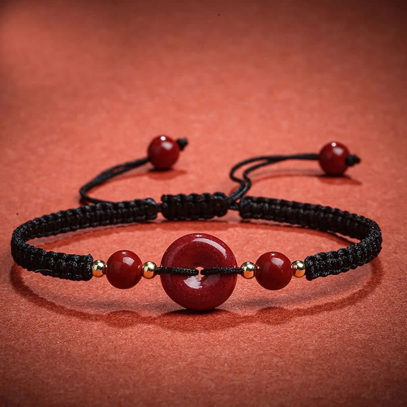 Black braided rope cinnabar bracelet with gold metal spacers adjustable knots