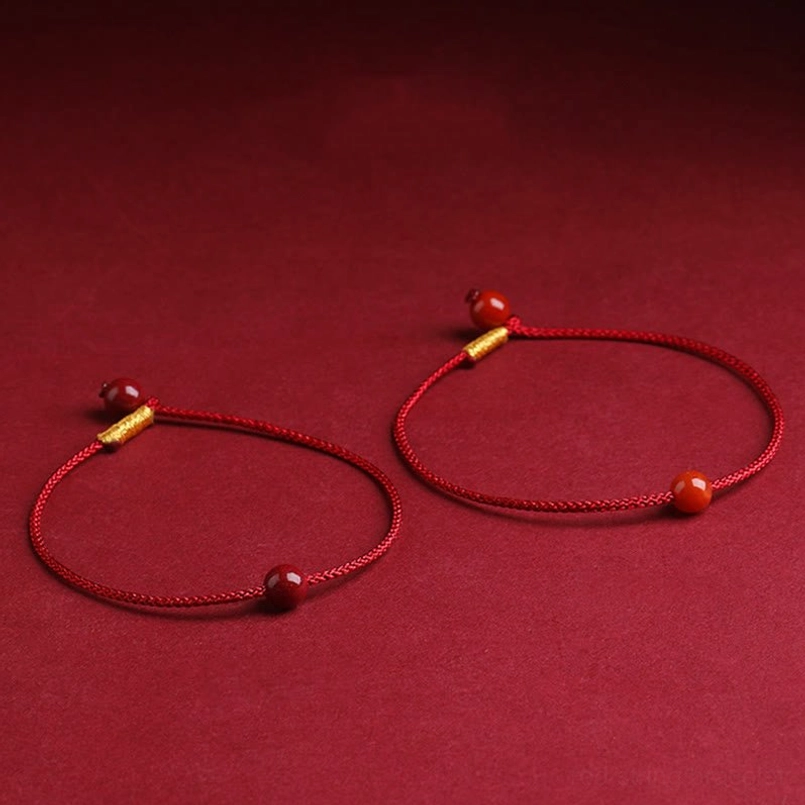 Two handmade cinnabar blessing bracelets with protective gold decorative elements