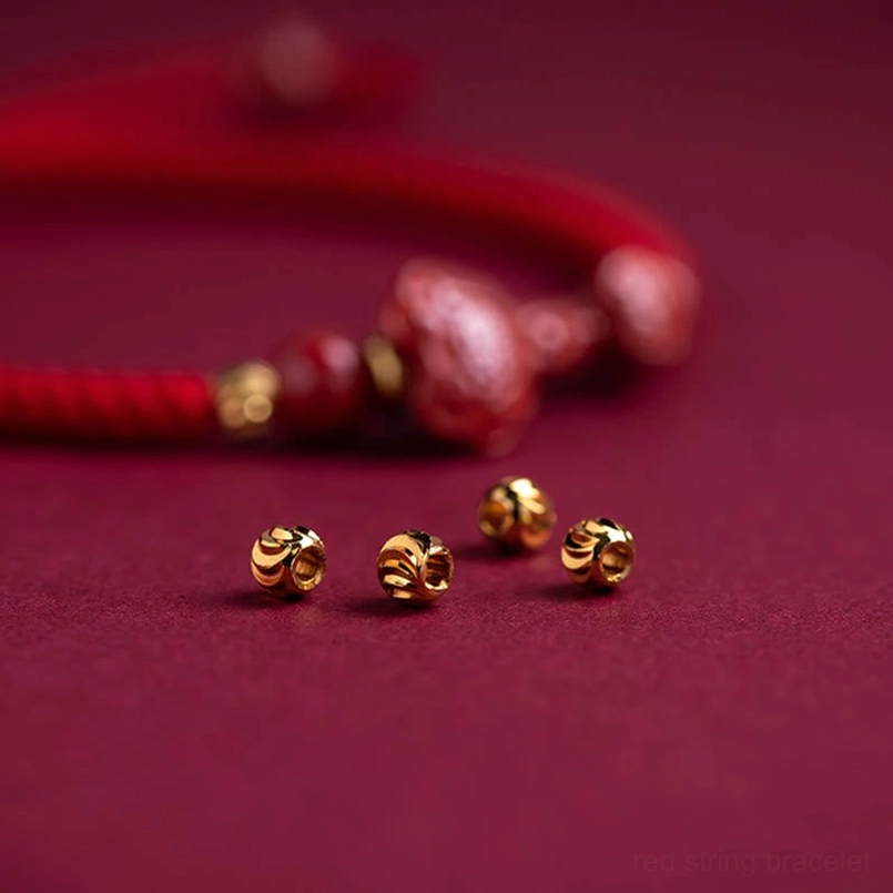 Loose components of handmade cinnabar bracelet including charms and spacer beads