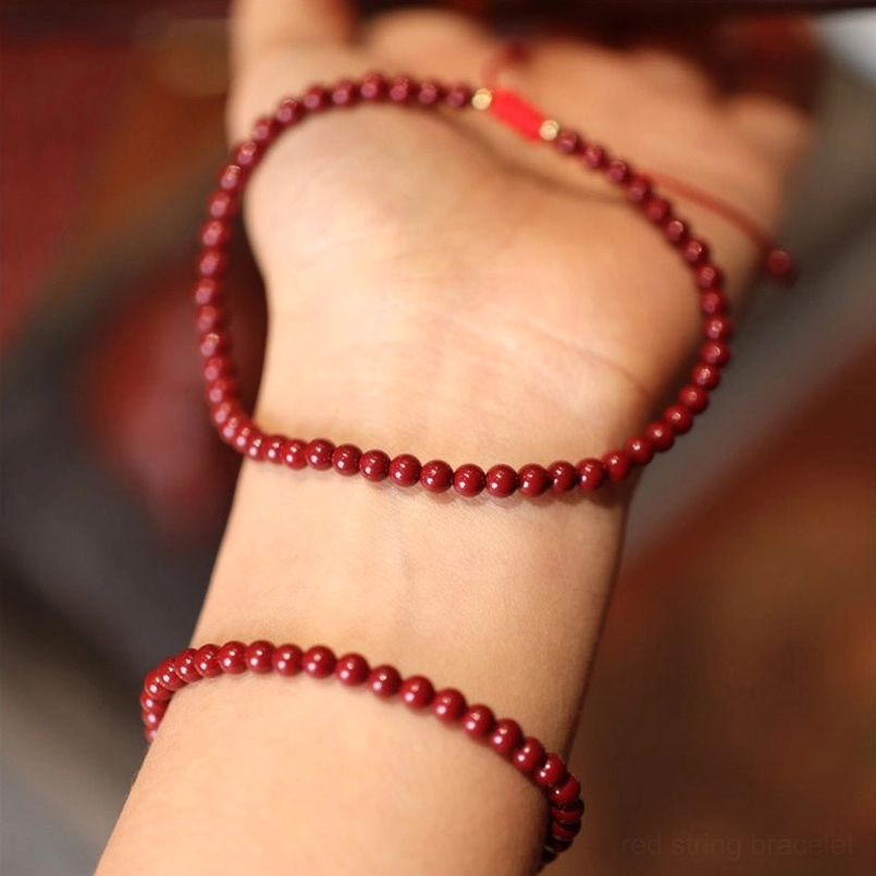 Two cinnabar beaded bracelets worn on wrists showing comfort fit and elegant styling