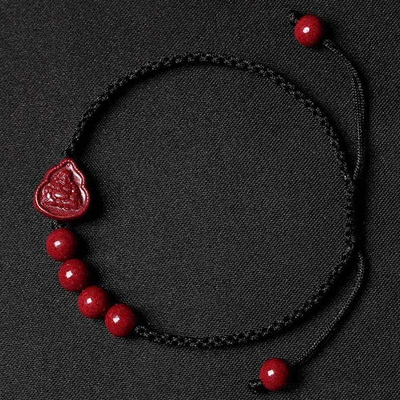 Cinnabar Buddha black string bracelet flat lay with beads and adjustable design