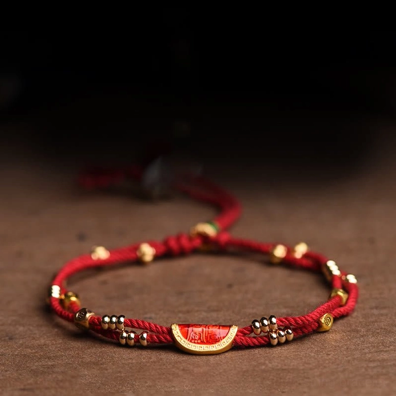 Cinnabar dumpling red string bracelet detail closeup of charm and beads