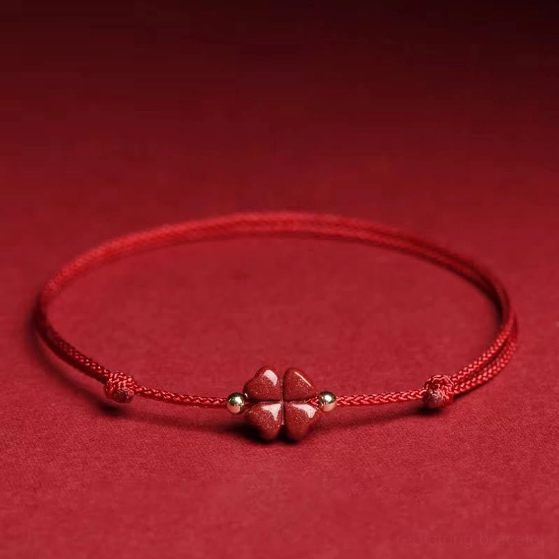 Cinnabar four leaf clover red string bracelet anklet with twisted rope detail flat lay