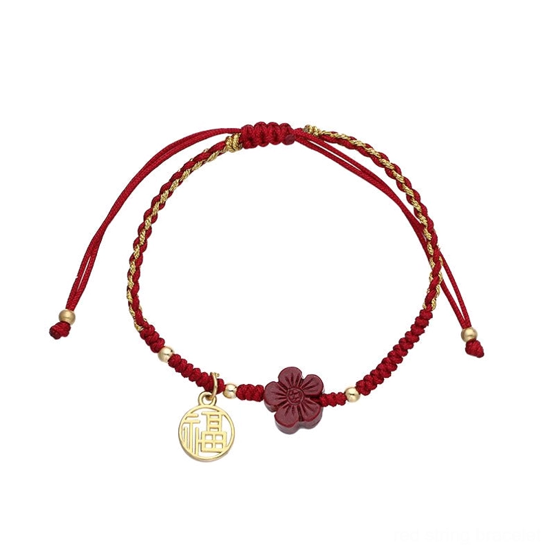 Double-layer woven red and gold cinnabar Fu charm bracelet flat lay