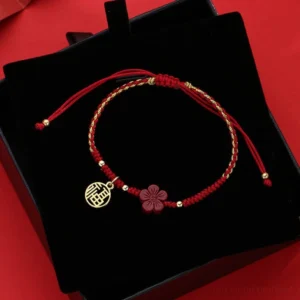 Cinnabar Fu character red string bracelet flat lay with adjustable drawstring closure