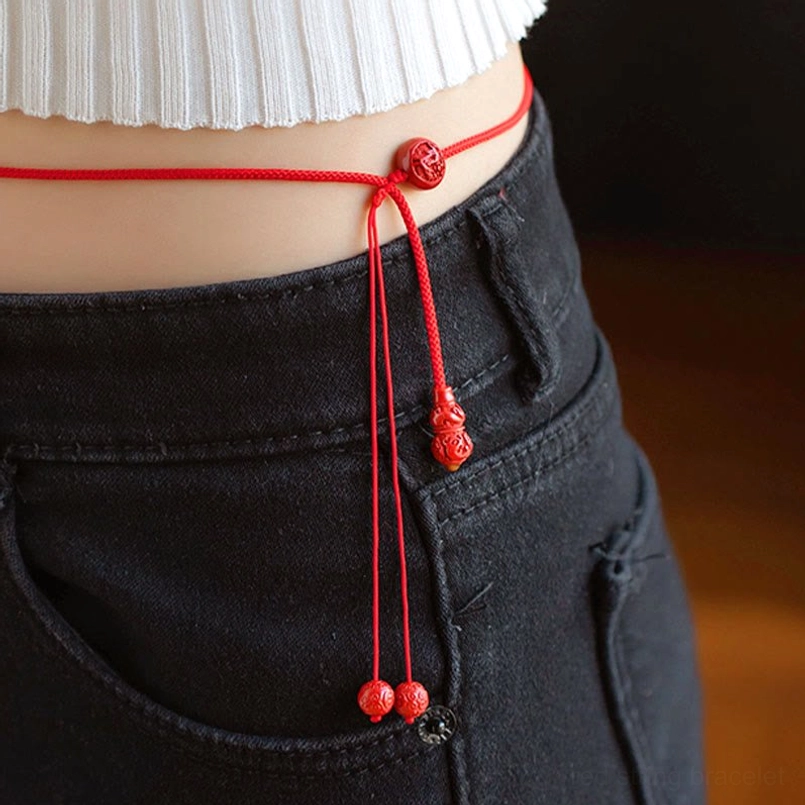 Adjustable red string belly chain with central carved cinnabar bead and tied knot