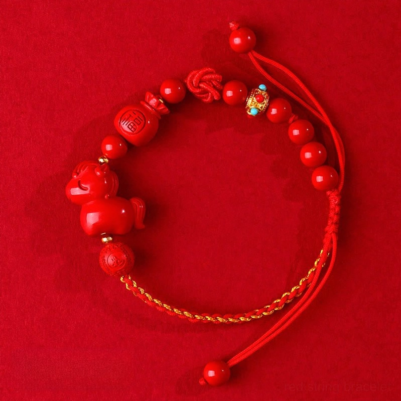 Cinnabar Horse Fu red string bracelet on solid red background