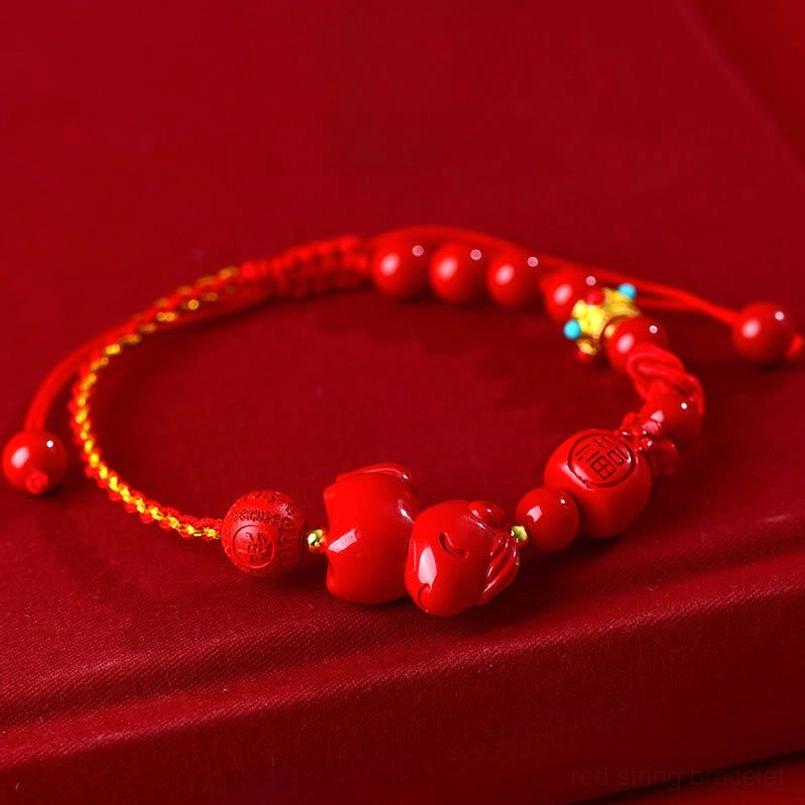 Flat lay view of cinnabar horse lucky red bracelet with sliding knot