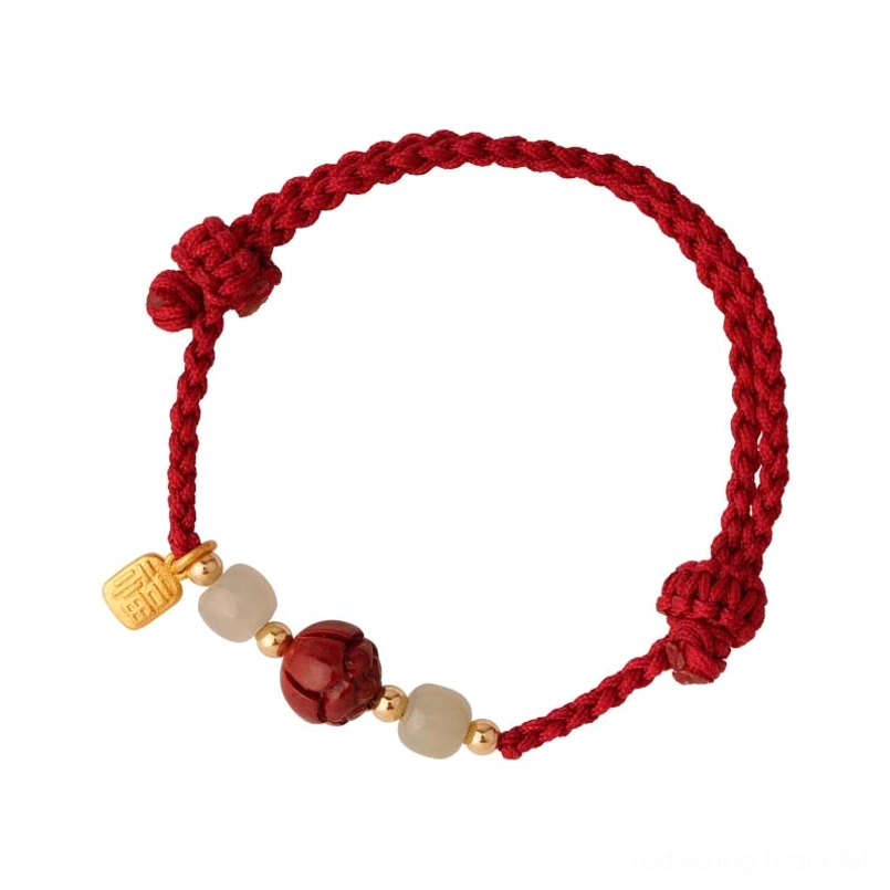 Full-view cinnabar charm bracelet with decorative knot ends and gold accents - flat lay