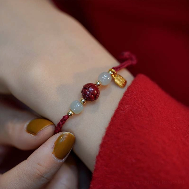 Cinnabar jade mixed bracelet with white jade beads and gold fu pendant on wrist