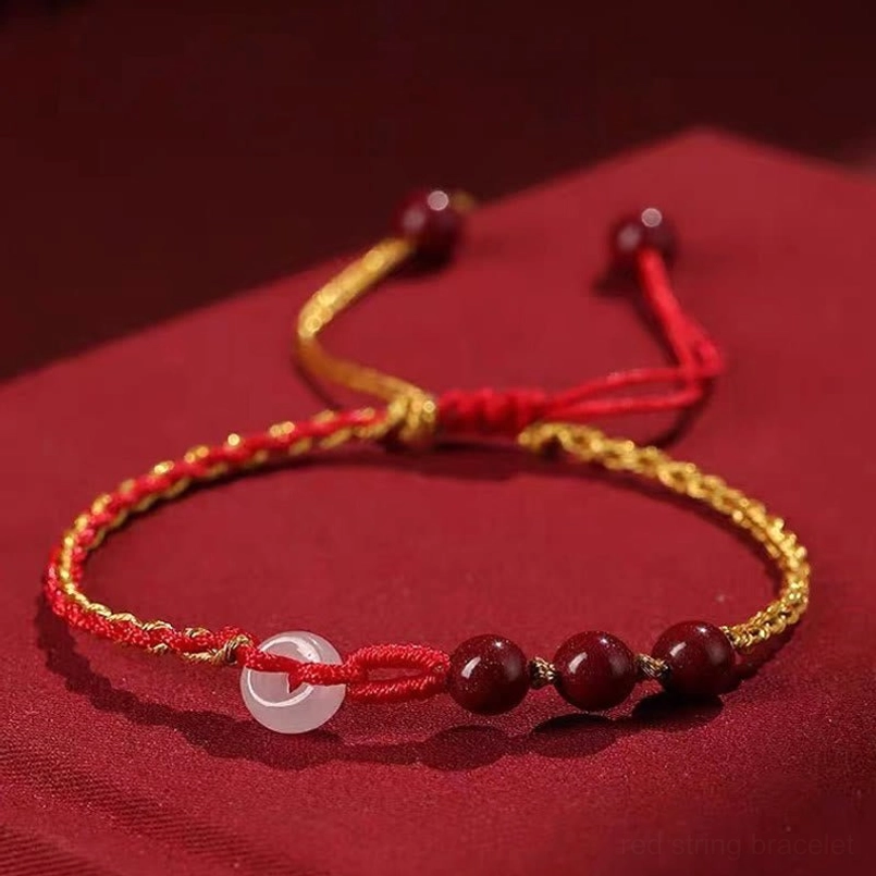 Cinnabar jade peace buckle bracelet top view showing adjustable cord straps