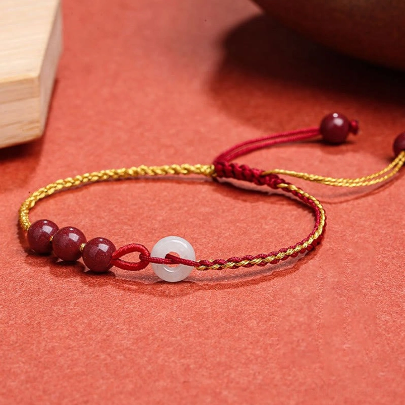Cinnabar jade peace buckle bracelet front close-up showing three cinnabar beads and white jade buckle