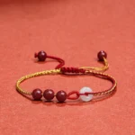 Cinnabar jade peace buckle blessing bracelet front view with red-gold woven rope and white jade peace buckle