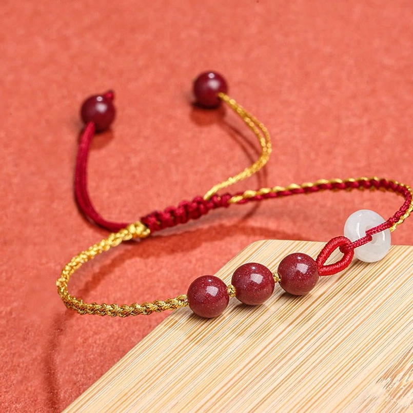 Cinnabar jade peace buckle bracelet top-down view displaying adjustable sliding knot