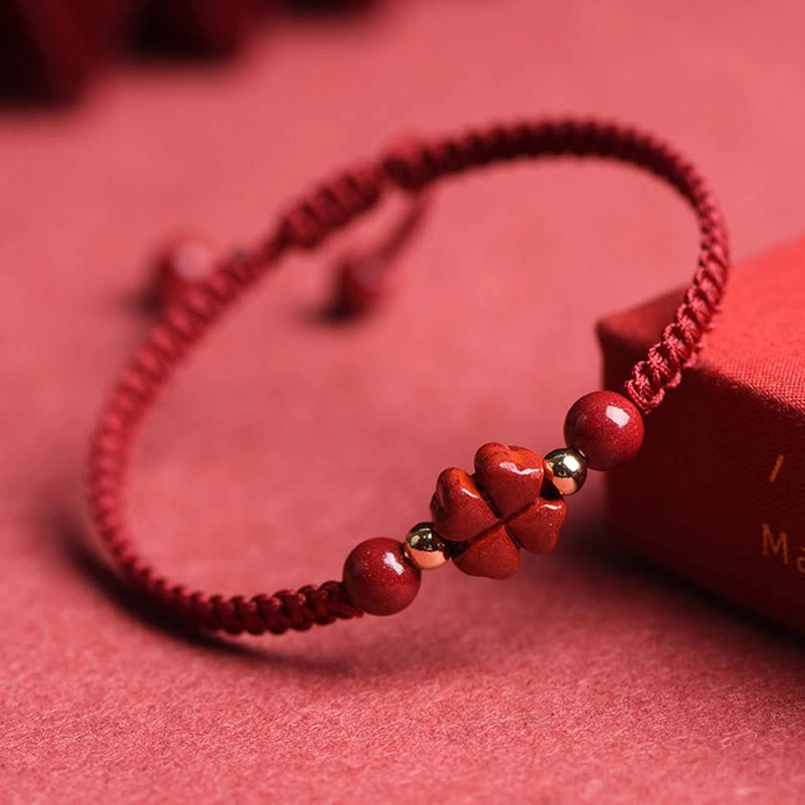 Four-leaf clover cinnabar red string bracelet side close-up with adjustable tie design