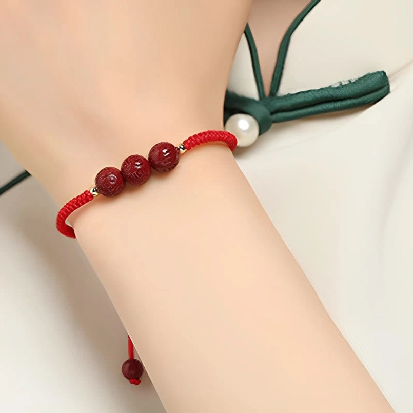 Handmade cinnabar mantra bracelet multiple beads worn on wrist styled photo
