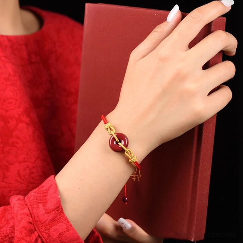 Cinnabar peace buckle bracelet worn close-up showing fit and gold hardware detail