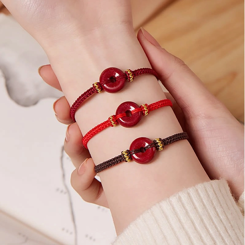 Cinnabar peace buckle bracelet detailed close-up of golden decorative knots
