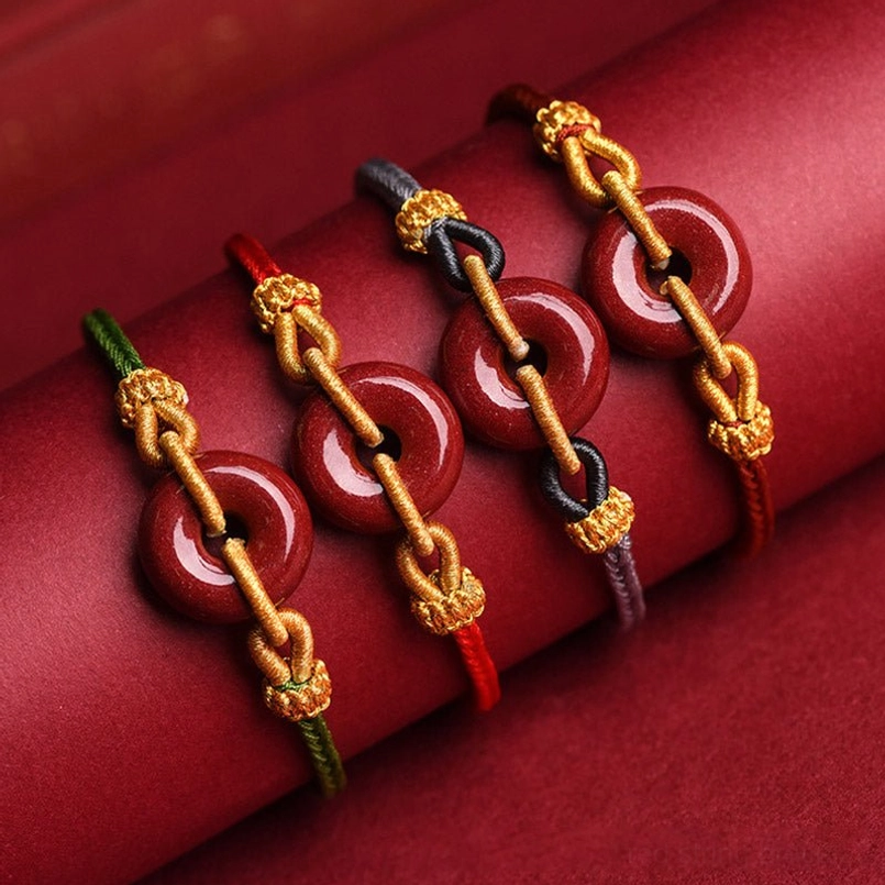 Multiple cinnabar peace buckle bracelets in different colored ropes, close-up display
