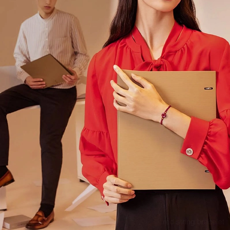 Person wearing cinnabar peace buckle bracelet in office scene