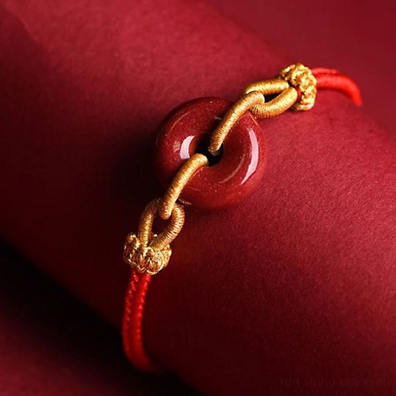 Cinnabar peace buckle bracelet side view showing gold metal knot and stone pendant