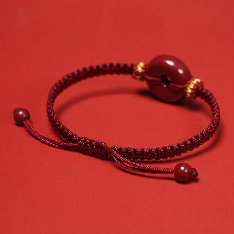 Cinnabar peace buckle bracelet top down view on bright red background