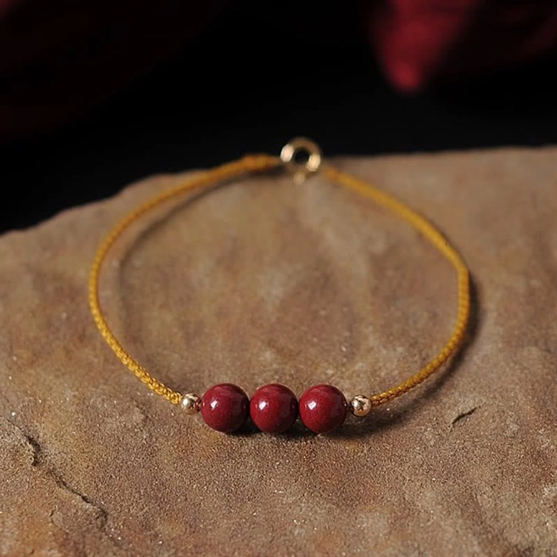 Cinnabar braided bracelet 3 red beads gold end caps yellow rope