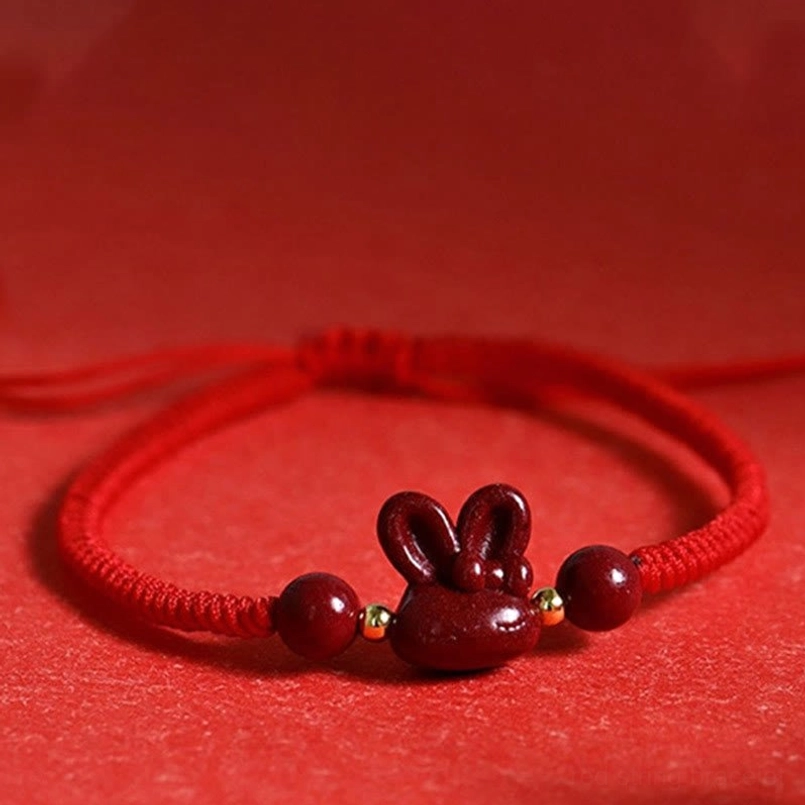Close-up detailed view of cinnabar rabbit bracelet showing braided rope texture and gold copper spacer beads