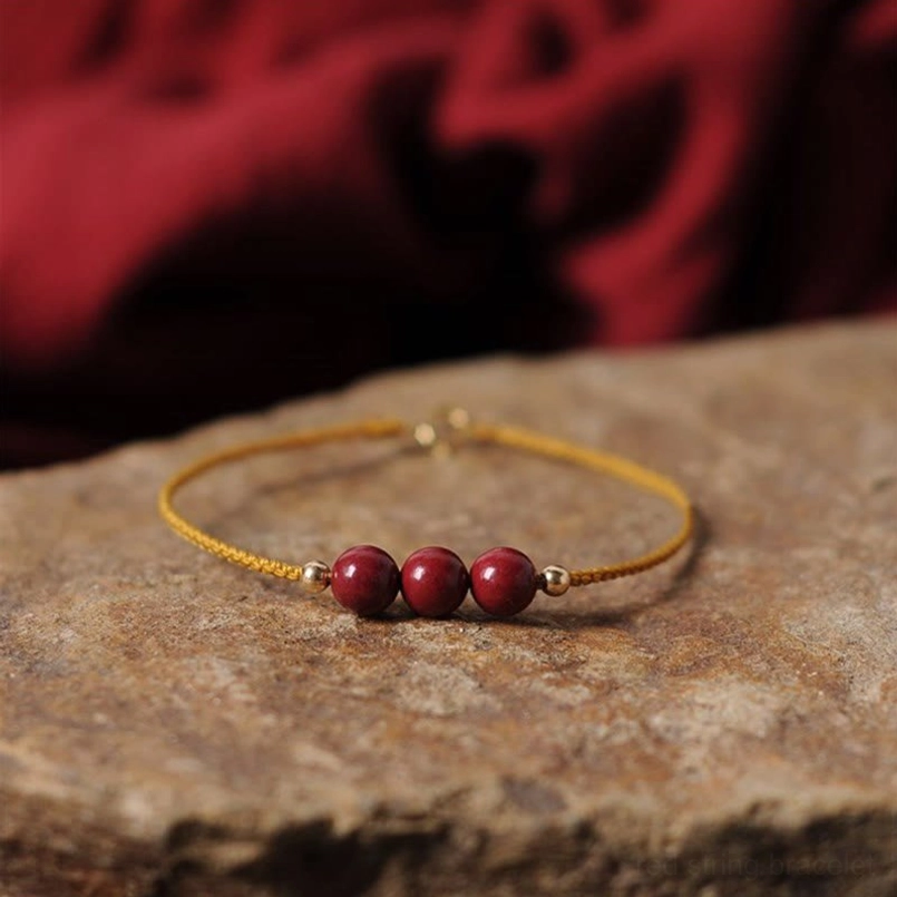 14K gold plated cinnabar bracelet side view woven cord gold clasp