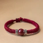 925 sterling silver cinnabar red braided string bracelet flat lay front view