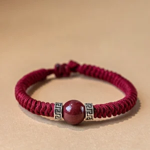 925 sterling silver cinnabar red braided string bracelet flat lay front view