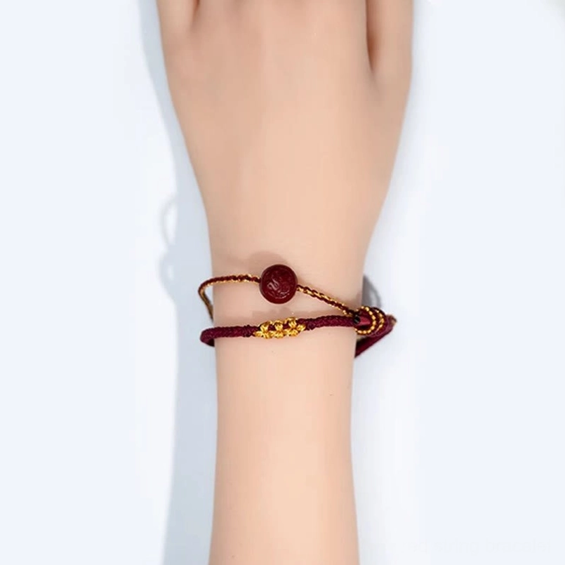 Red string cinnabar bracelet worn on wrist showing fit and comfort