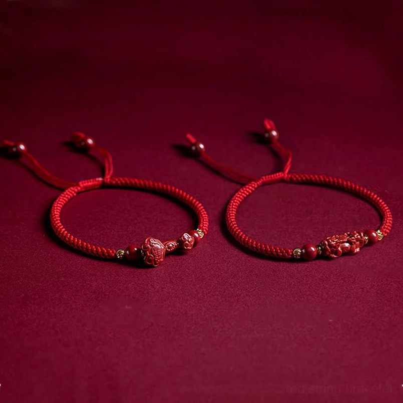 Red string bracelet with cinnabar beads and gold accents elegant styling