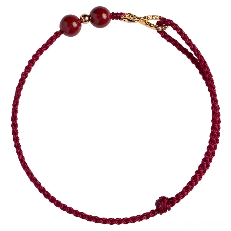 Full view cinnabar red string infinity bracelet with adjustable knot and gold charm on white background